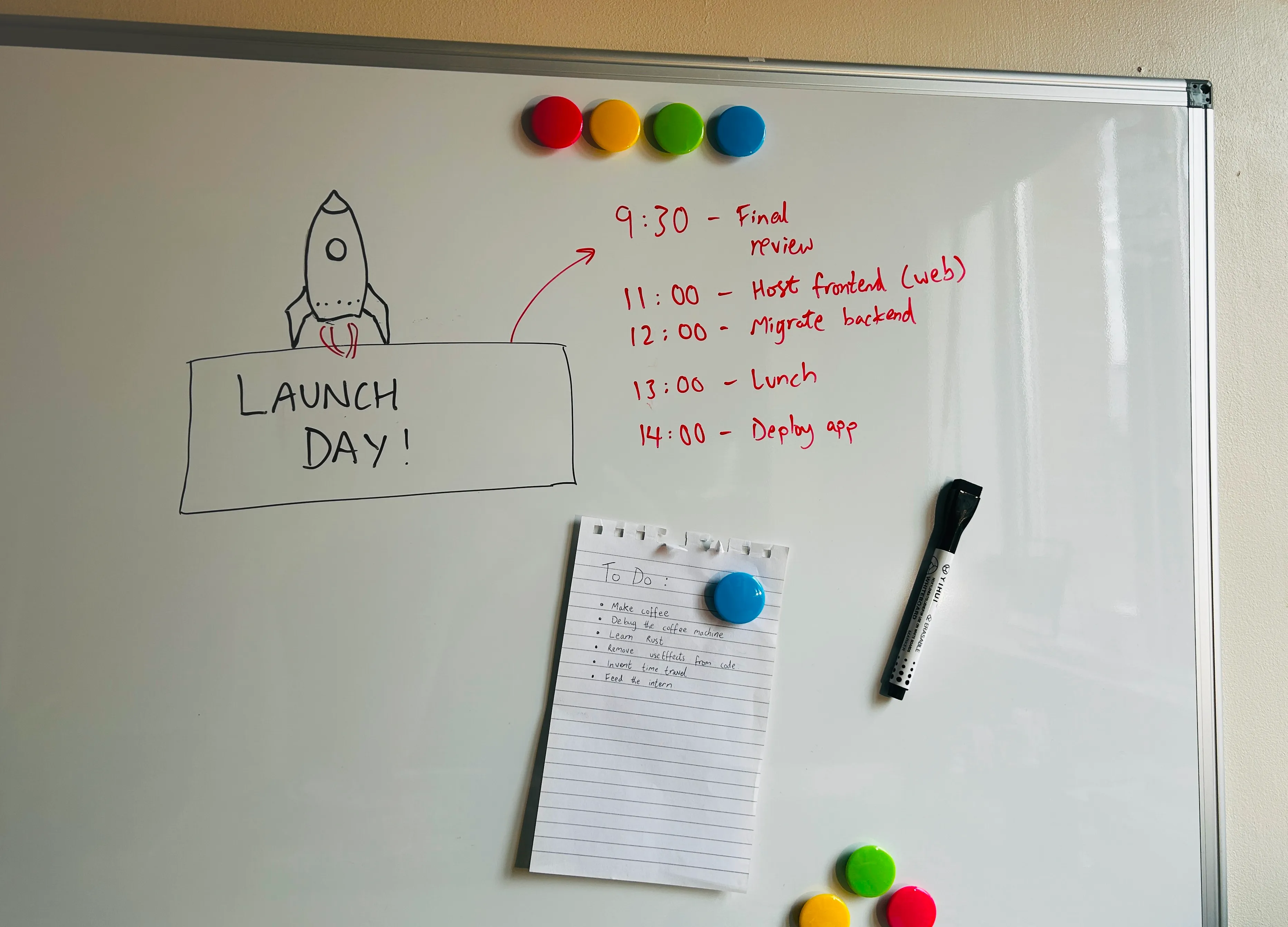 Whiteboard with a schedule on it and a note saying 'LAUNCH DAY!'